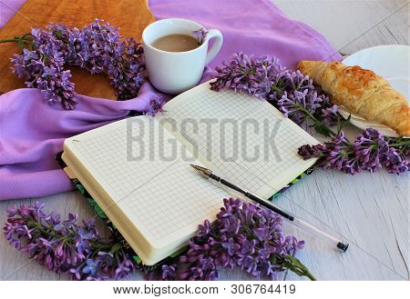 Morning, Spring. Business Breakfast - Notebook, Cup Of Coffee, Croissant And Lilac Branches. Spring 