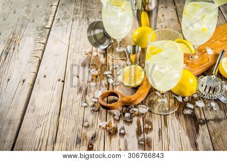 Trendy Summer Cold Drink. St Germain French Spritz Cocktail With Lemon Slices, Old Rustic Wooden Bac