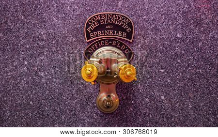 Fire Standpipe Outdoors On An Office Building Stone Facade, New York, Manhattan Downtown