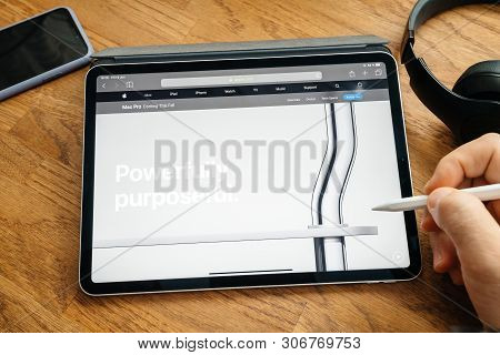 Paris, France - Jun 6, 2019: Man Reading On Apple Ipad Pro Tablet About Latest Announcement Of At De