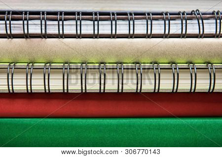 Spines Of Books And Ring Binder Notebooks In Stack, Close Up Shot