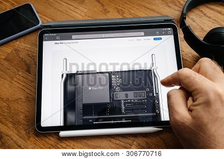 Paris, France - Jun 6, 2019: Man Reading On Apple Ipad Pro Tablet About Latest Announcement Of At De