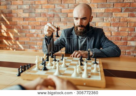 Chess player playing black figures, queen move
