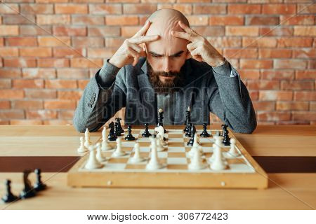 Male chess player playing, thinking process