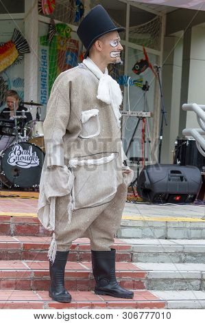 Male Actor In Bright Clothes And Cilinder Plays A Meme In A Street Theater, Surgut, Russia - June 12