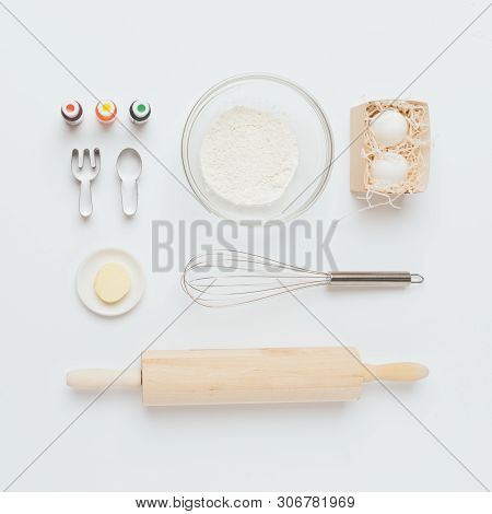 Baking Tools And Ingredients: Flour And Eggs, Butter, Food Dyes, Rolling Pin, Whisk, Cookie Cutters,