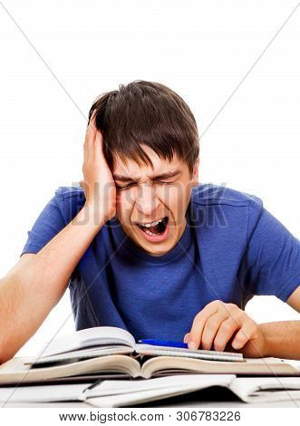 Tired Student Yawning At The Writing Table On The White Background
