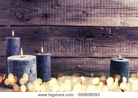 Black  Burning Candles  On Aged  Rustic Wooden Textured Background. Spa Or Still Life Concept. Selec