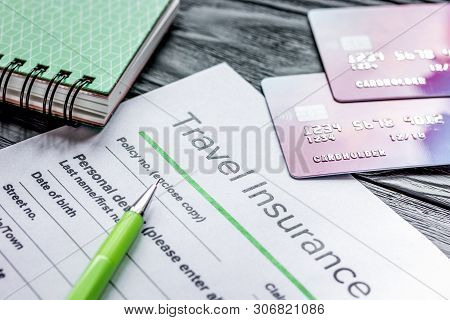 Booking Travel Concept With Insurance On Wooden Table Background