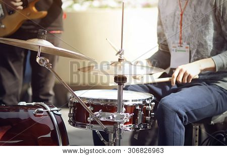 The Drummer, One Of The Street Musicians Participating In The Event, Plays Drumsticks On A Burgundy 