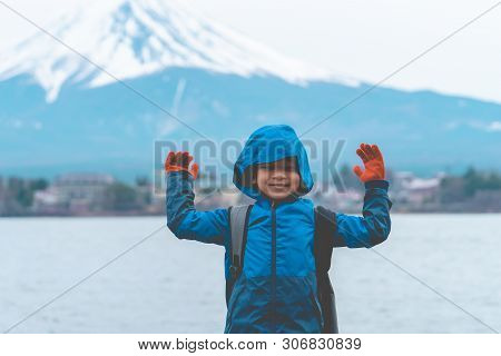 Kid Is Standing In Front Of Kawaguchiko Lake And Mount Fuji In Winter.