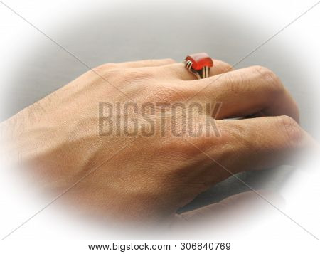 Yemen Red Aqeeq Agate Stone. Male Hand With Ring On Ring Finger With Dark Background. Yemeni Akeek R