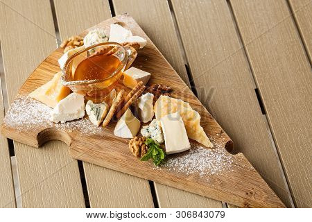 Tasting Cheese Dish On A Wooden Plate. Food For Wine And Romantic, Cheese Delicatessen On A Wooden R