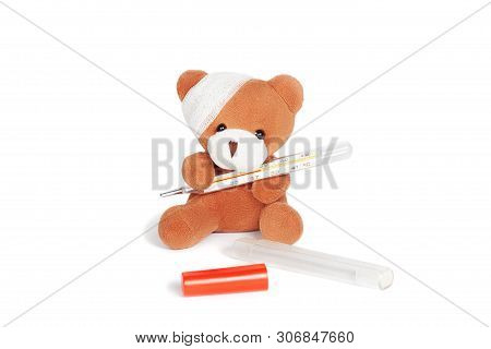 Teddy Bear With Bandage Sitting And Holding Termometer. Illness, Complication After Injury, High Tem