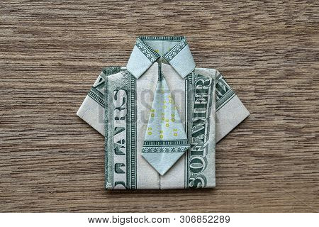 Origami Shirt Made Of Dollar Banknote On Wooden Background. Closeup. Dollar Bill T-shirt