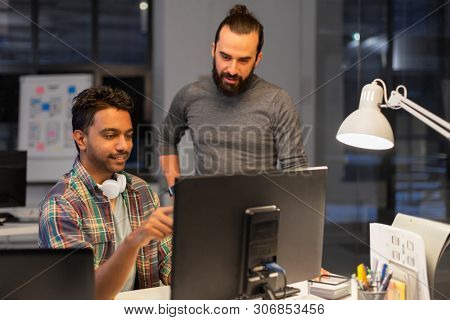 deadline, technology and people concept - creative team s with computers working together late at night office