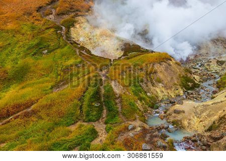 Water Vapor Over The Valley Of Small Geysers. View Of The Eastern Mountain Covered By Clouds, Jelize
