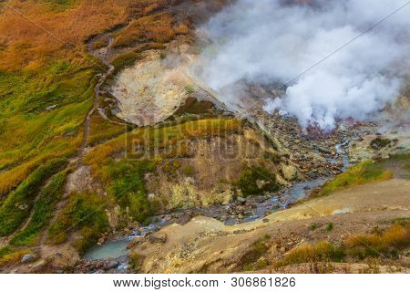 Water Vapor Over The Valley Of Small Geysers. View Of The Eastern Mountain Covered By Clouds, Jelize