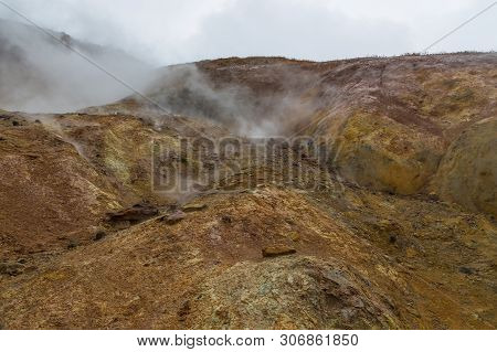 Water Vapor Over The Valley Of Small Geysers. View Of The Eastern Mountain Covered By Clouds, Jelize