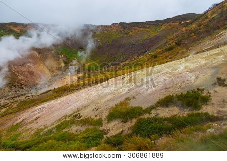 Water Vapor Over The Valley Of Small Geysers. View Of The Eastern Mountain Covered By Clouds, Jelize