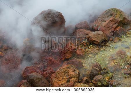 Water Vapor Over The Valley Of Small Geysers. View Of The Eastern Mountain Covered By Clouds, Jelize