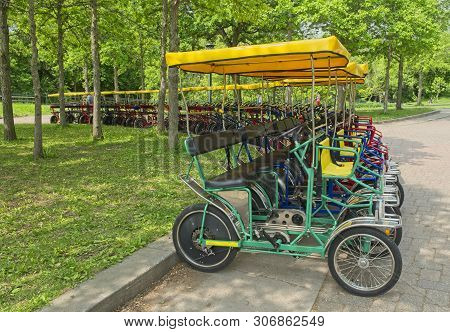Four Wheel Rental Bikes Lined Up For Pleasure Biking Around The Park