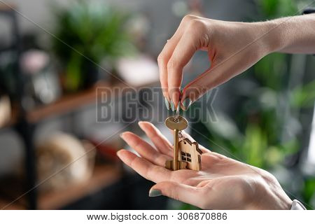 Mortgage Concept. House Key In Womans Hands. Young Woman. Modern Light Lobby Interior. Real Estate, 