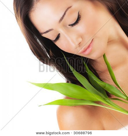 Frisk kvinna avkopplande spa, sensuella kvinnliga porträtt med färska blad, unga damen med spri