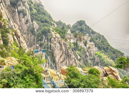 The Sky High Suspension Bridge On The Sanhuangzhai Plank Walk Way With The Sanhuang Temple Within Th