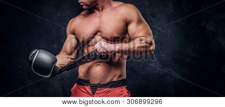 Serious Muskular Man Get Prepared For Boxing, His Is Wearing His Boxer Gloves.