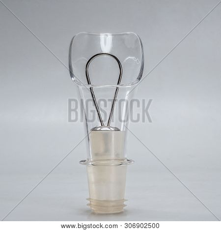 Wine pourer and wine stopper on light gray background
