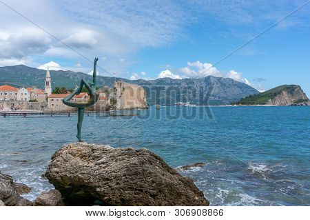 Budva, Montenegro Statue Of A Ballerina Dancer Of Budva Against The Old Town Of Budva Near Mogren Be