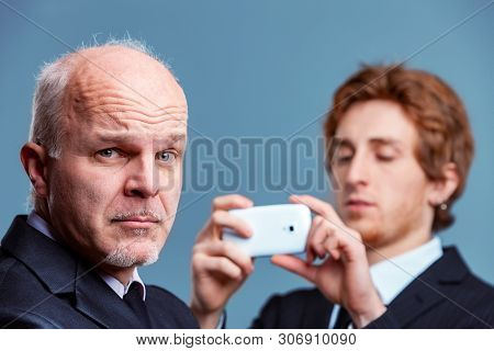 Senior Businessman Pulling A Quizzical Face