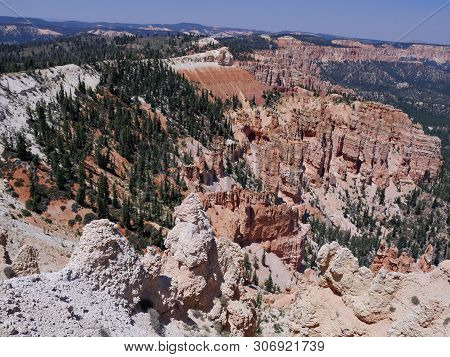 Impressive View Of Layered Rock Formations With Pine And Spruce Trees Growing On The Clifflines At B