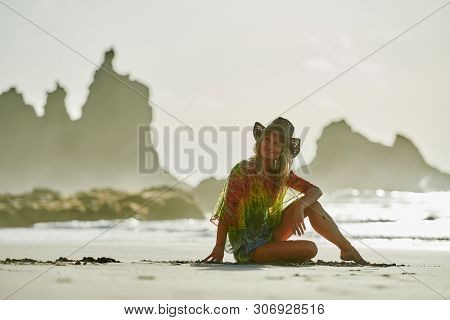 young woman relaxing on the beach in summer day