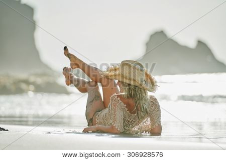 young woman relaxing on the beach in summer day