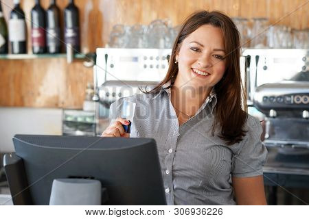 Bartender Registrating New Order By Cash Register. A Restaurant Worker Registrating New Order By Cas