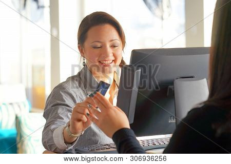 Bartender Registrating New Order By Cash Register. A Restaurant Worker Registrating New Order By Cas