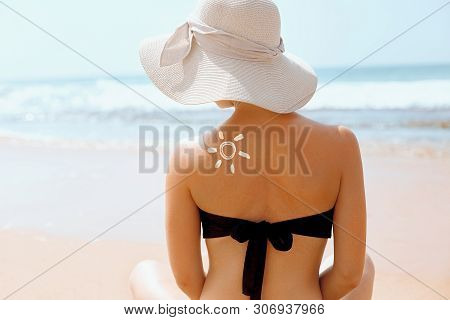 Suncream. Suntan Lotion Beautiful Woman Applying On Beautiful On Shoulder In Form Of The Sun. Sunscr