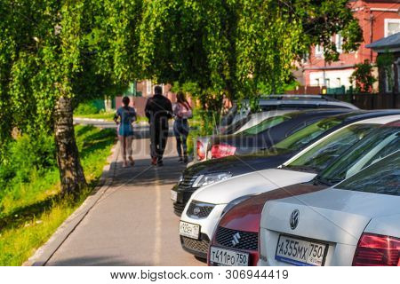 Sergiyev Posad, Russia - June, 8, 2019: familie jogs in the park in Sergiyev Posad, Russia