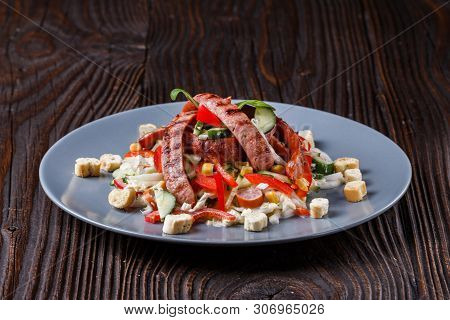 Salad With Grilled Sausage Paprica Cucumber And Croutons