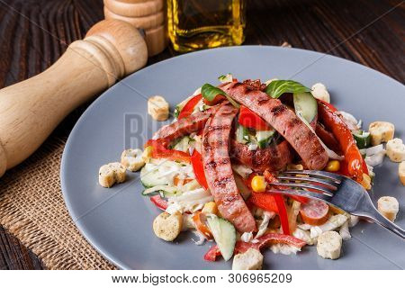 Salad With Grilled Sausage Paprica Cucumber And Croutons