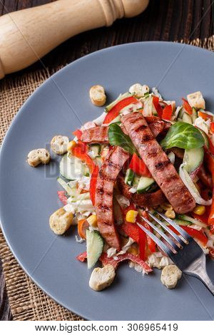 Salad With Grilled Sausage Paprica Cucumber And Croutons