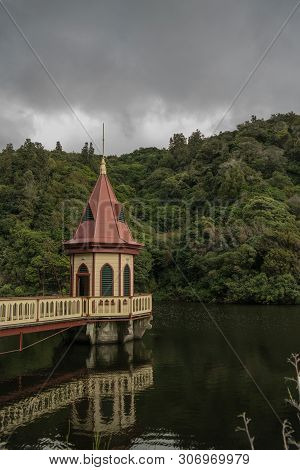 Historic Pumphouse In The Middle Of A Dam
