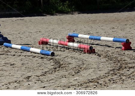 Image Of Show Jumping Poles On The Training Field. Wooden Barriers For Jumping Horses As A Backgroun