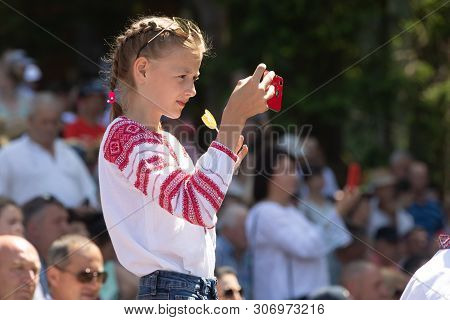 Ivano-frankivsk Reg, Ukraine - Jun. 15, 2019: Girl With A Smartphone At The Festival Polonynsky Summ
