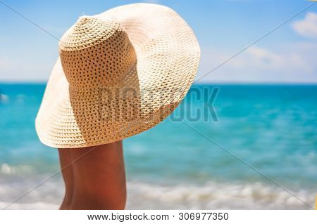 Happy Baby Boy In The Srtaw Hat Turned Back. Child Injoying Summer Day At The Beach. Outdoor