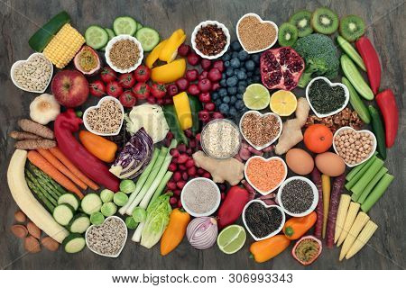 Healthy food choice with super food of fruit, vegetables, seeds, legumes, cereal, grains, nuts, herbs and spices. High in antioxidants, anthocyanins, protein, vitamins and dietary fibre. Flat lay.
