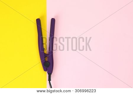 Modern Hair Iron For Straightening On Color Background, Top View With Space For Text