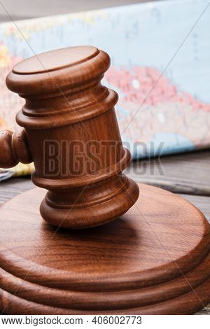 International Court Concept. Wooden Gavel And World Map Vertical Shot.